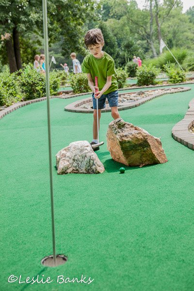Child Playing Miniature Golf
